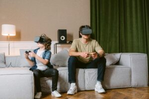 A father and son enjoying virtual reality gaming in their living room with VR headsets and controllers.